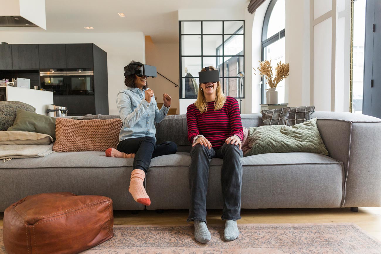 Women playing with VR glasses