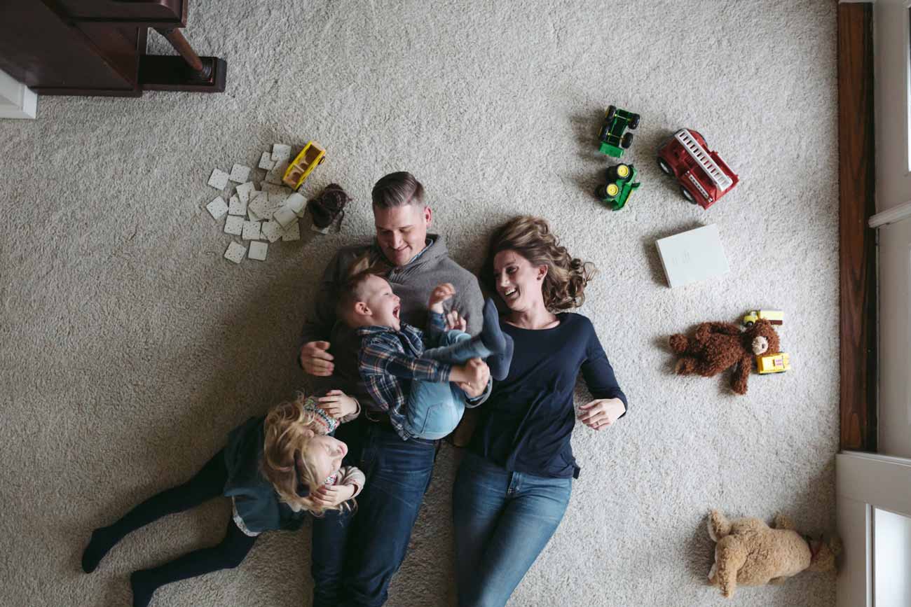 family of four playing on the floor together