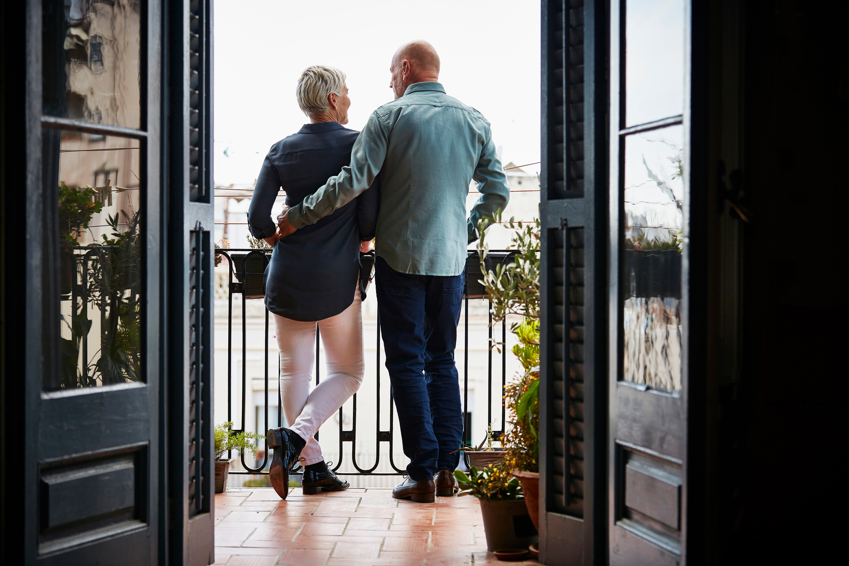 Happy Senior Couple standing on Balcony