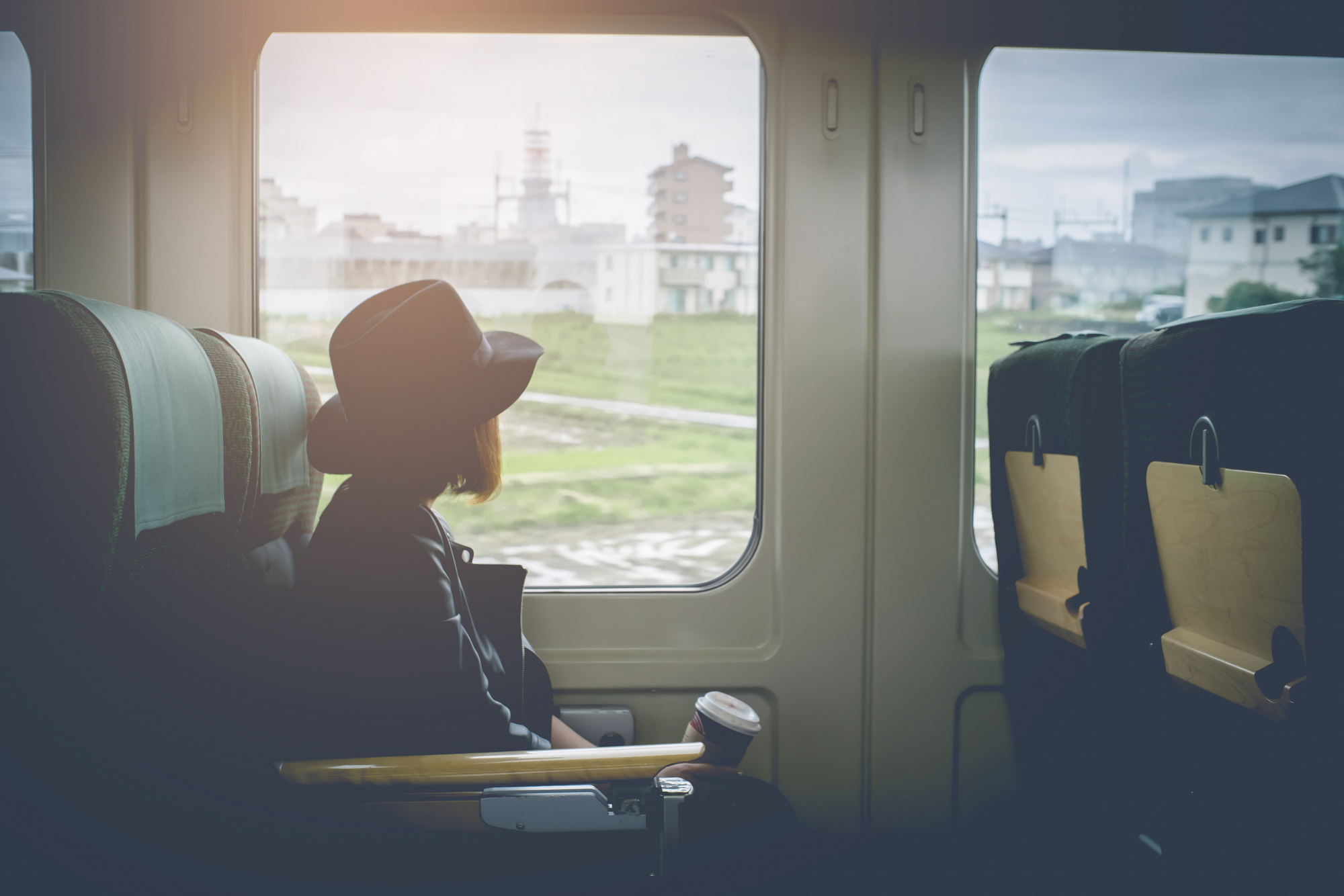 Japanese traveler on a train overlooking the window