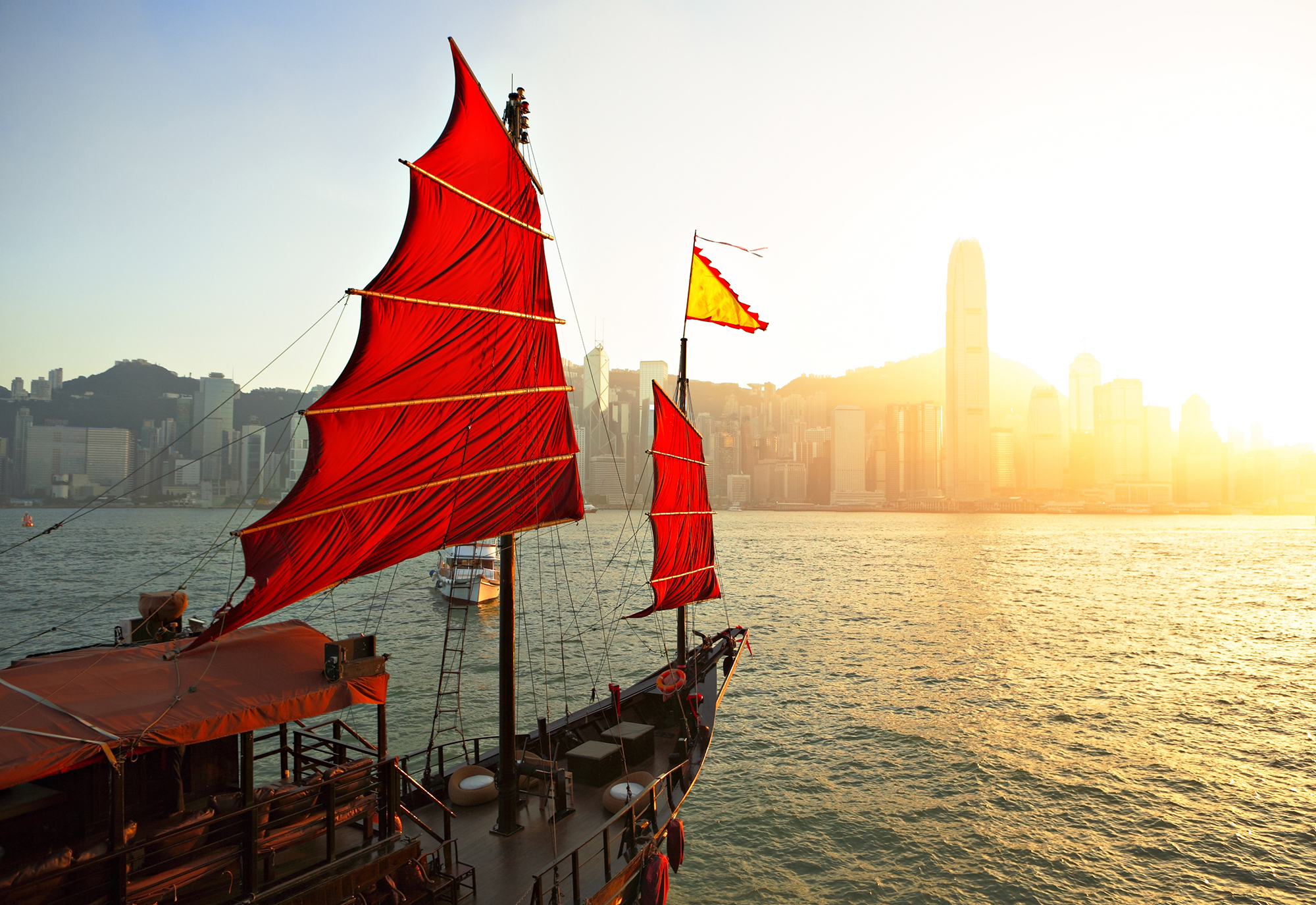 Junk boat on the Hong Kong harbour at sunset.