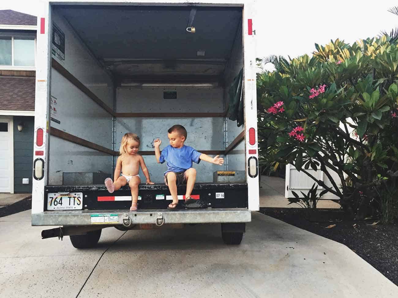 little kids playing inside a moving van