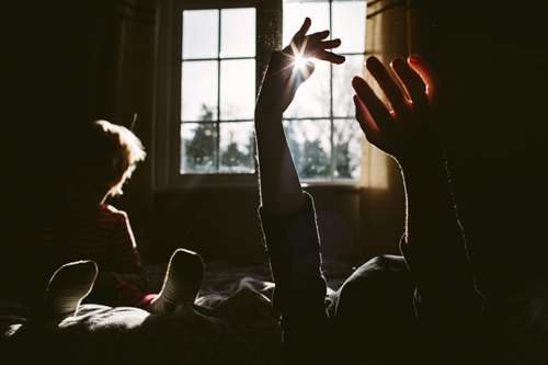 silhouette of children by the window