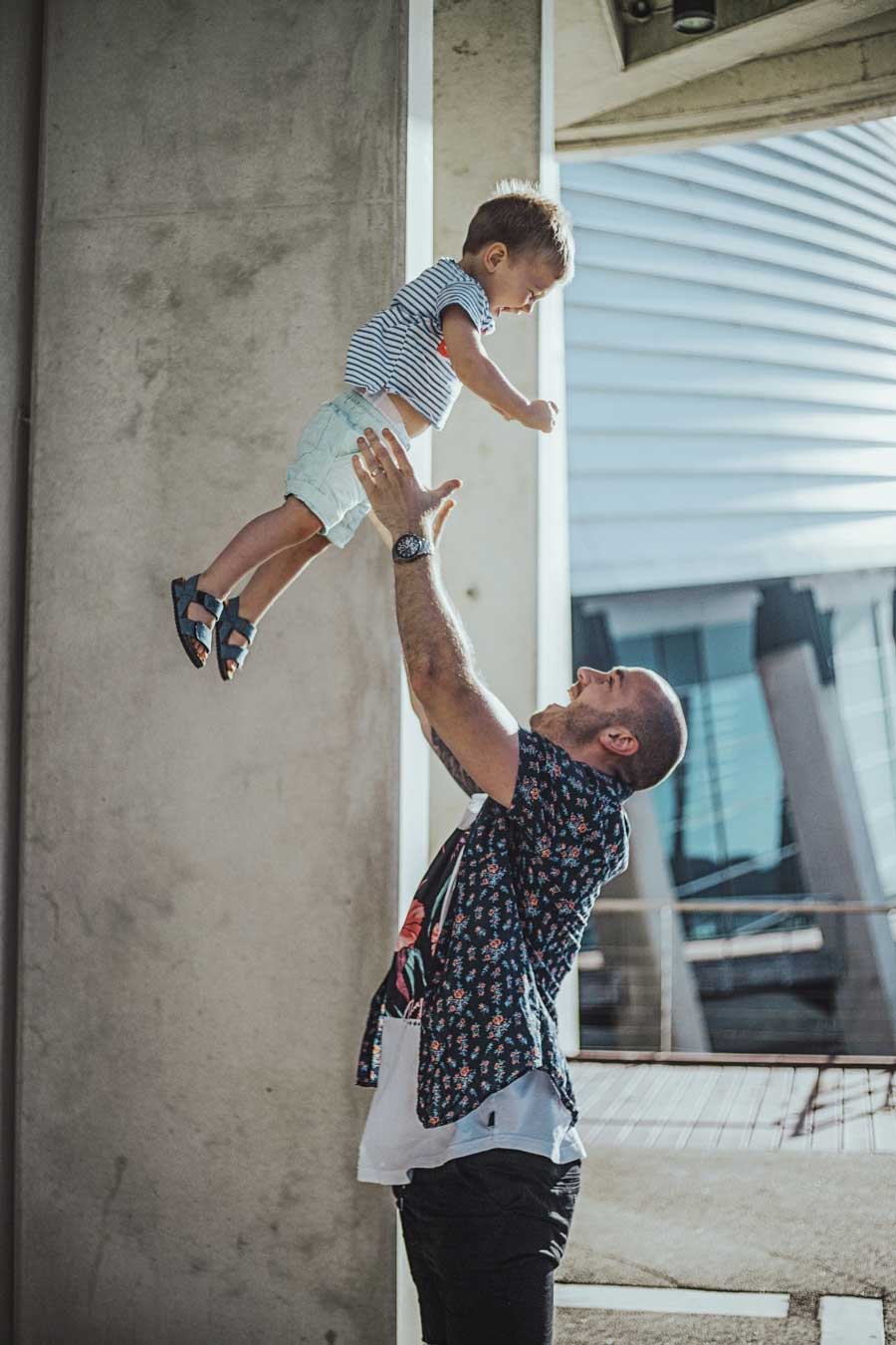 son trusting his dad to throw him up into the air