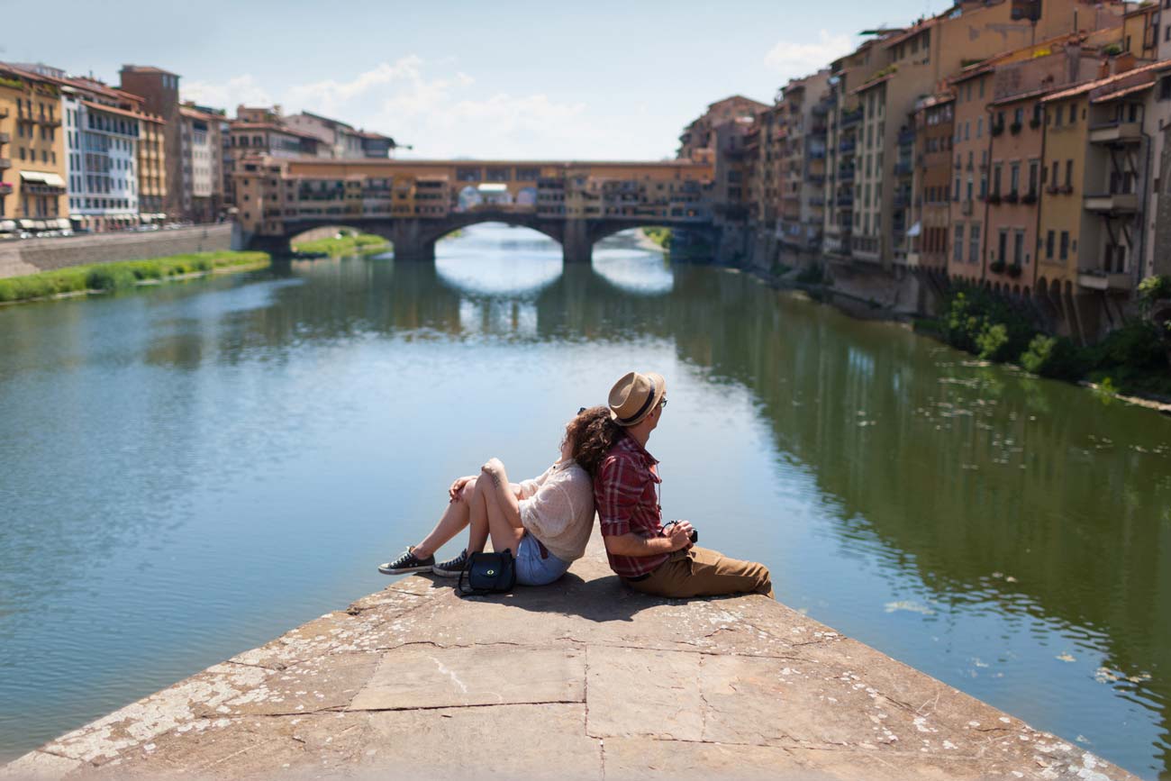 young travellers overlooking Ponte Vecchio in Florence Tuscany Italy